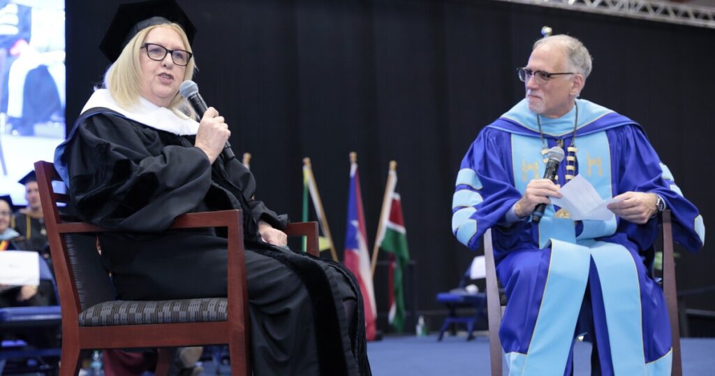 Misericordia University President Daniel Myers, left, helps adjust former Irish President Mary McAleese's sash as part of the granting of an honorary degree at the university's Winter Commencement Ceremony as Misericordia University Board of Trustees President Deborah Smith-Mileski, right, assists.