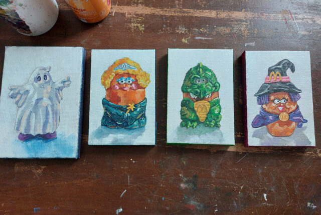 A photo of four paintings of 1990s ephemera toys