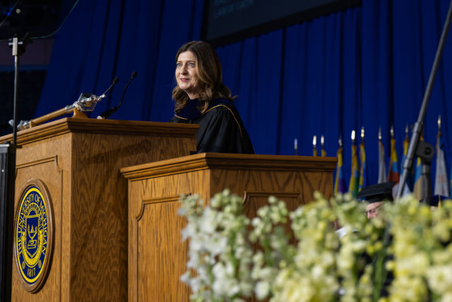 Photo of commencement speaker Rebecca Blumenstein delivering the address