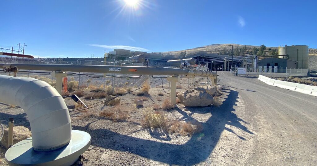 This is an image a geothermal power plant in a desert landscape.