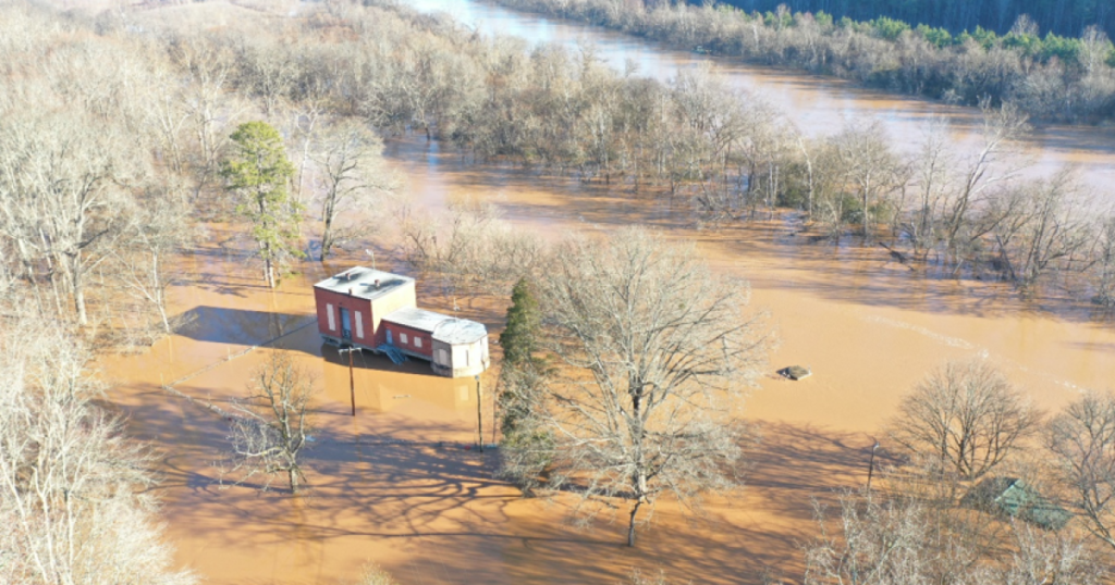 A maintenance crew drives a boat to the Hannah Ferry Pump Station during a flood.