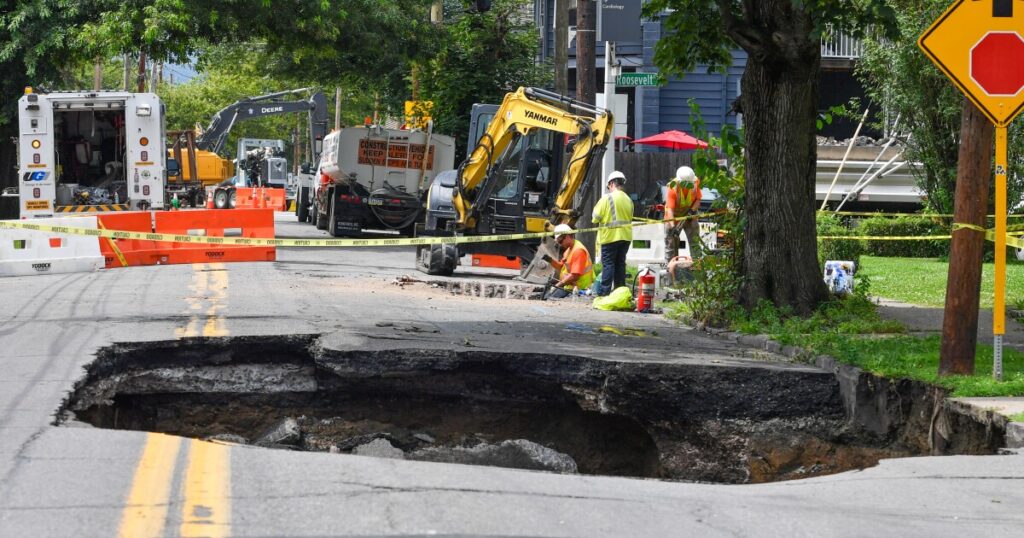 Workers continue repairs at the site of a June 25 sinkhole on Horton Street, Wilkes-Barre on Monday, July 14, after a second sinkhole opened about a half block away.