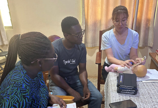 A woman conducts a training session with two people
