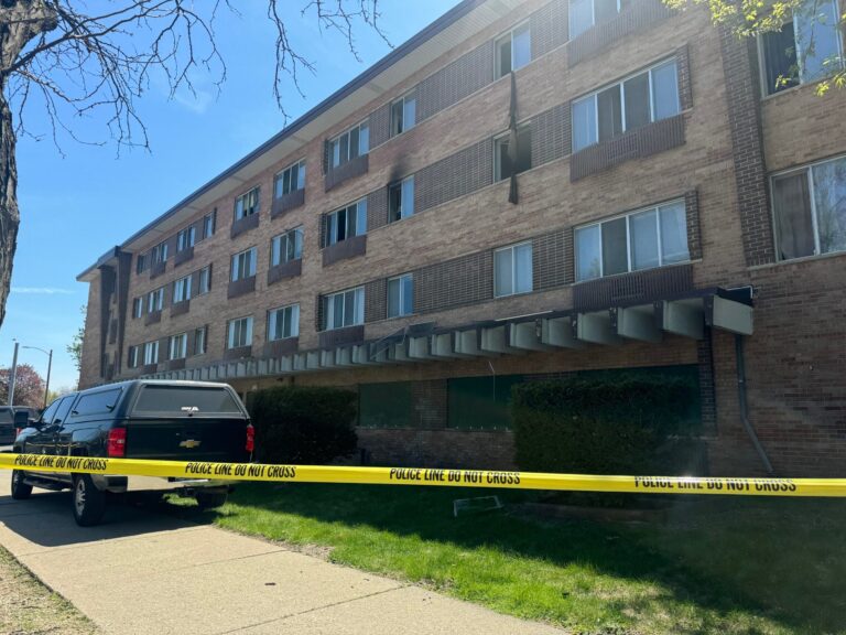 State Sen. Johnson speaks into microphones at a podium.