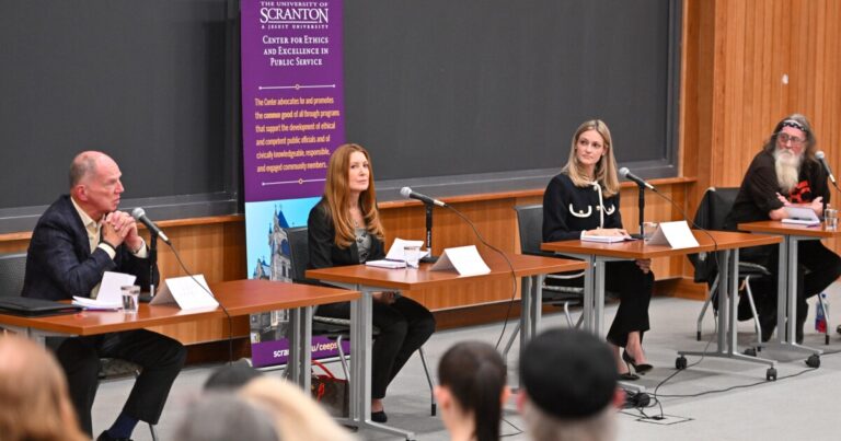 WVIA News reporter Borys Krawczeniuk, left, who served on Thursday night's panel, asks a question during the Scranton mayoral