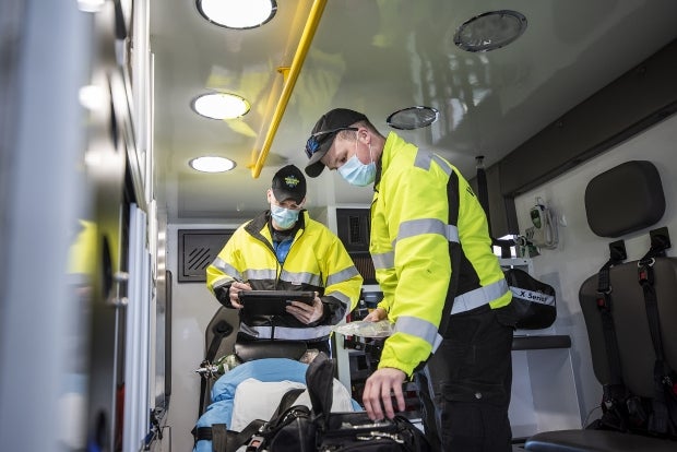 Paramedics check one of the two ambulances at their station