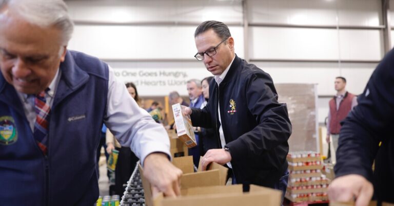 (Left to right) State Rep. Kyle Mullins, Rep. Bridget Kosierowski, co-owner of Brace's Orchard Logan Brace, Gov. Josh Shapiro, Rep. Jim Haddock, Rep. Eddie Day Pashinski, Rep. Kyle Donahue and CEO of Weinberg Northeast Regional Food Bank Jennifer Warabak joined to pack groceries and talk about the state's efforts to support food banks with SNAP benefits on pause for more than 2 million Pennsylvanians.
