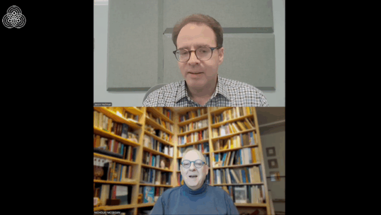 Two people on a video call; the top person sits in front of a gray sound panel, while the bottom person sits in a room with shelves filled with books.