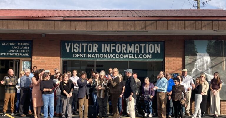 Residents examine the new maps at the McDowell County visitor center on Thursday, Nov. 20, 2025.
