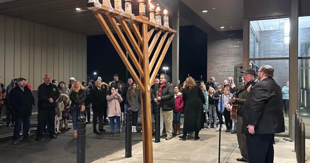 Rabbi Daniel Swartz sits in his office at Temple Hesed in Scranton with a Hanukkah sweater that depicts a dreidel and says, 'That's how I roll.' A dreidel is a four-sided top inscribed with Hebrew letters, and traditionally used during Hanukkah.