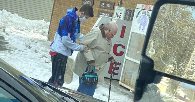 man-helps-elderly-woman-cross-street