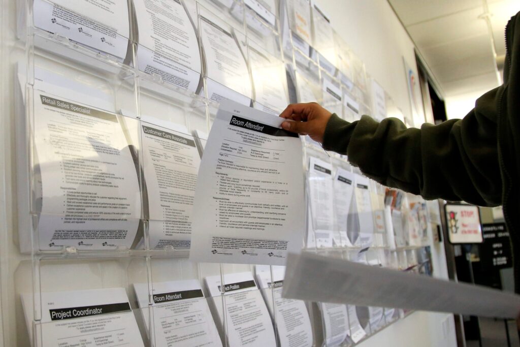 A job seeker grabs a flyer advertising a job