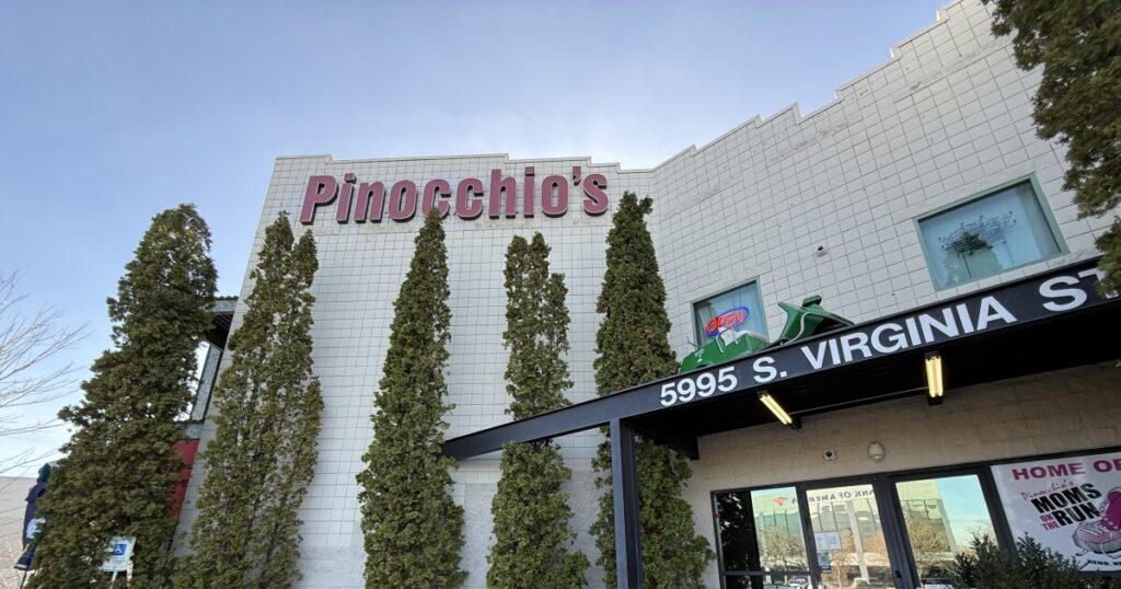 Restaurant manager Jillian Pinocchio stands in front of the Moms on the Run poster.