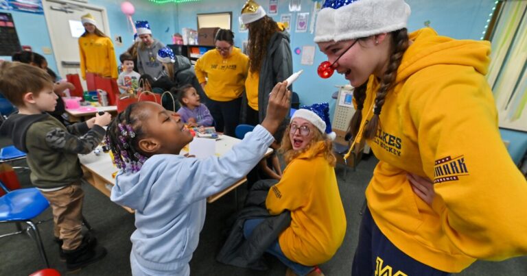 Bradley Simeon hugs Santa after receiving a Christmas gift from the Wilkes baseball team.