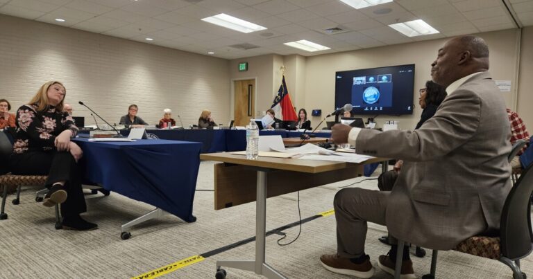 John Miall (foreground) and Asheville Vice Mayor Antanette Mosley at the Buncombe County Board of Elections hearing on Jan. 20, 2025 where the board determined Mosley is eligible to run for Asheville City Council, despite challenges from Miall.