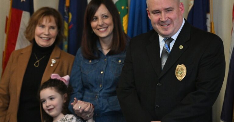 Capt. Michael Boyle talks to his youngest daughter Casey, 6, before being sworn in as Wilkes-Barre's new police chief.