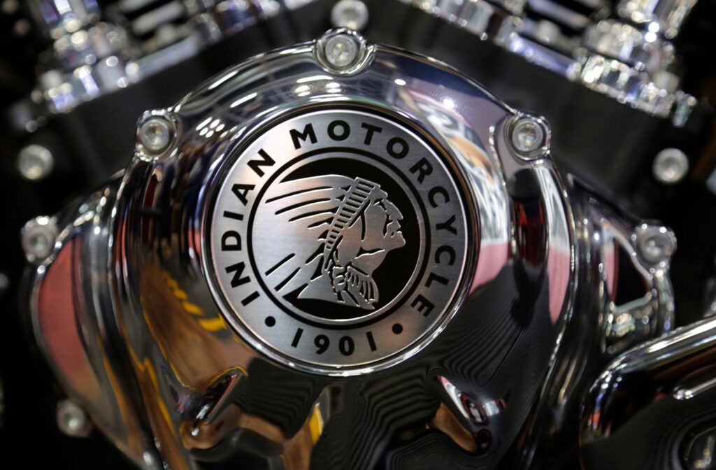 Close-up of a chrome engine cover featuring the Indian Motorcycle logo and the year 1901.