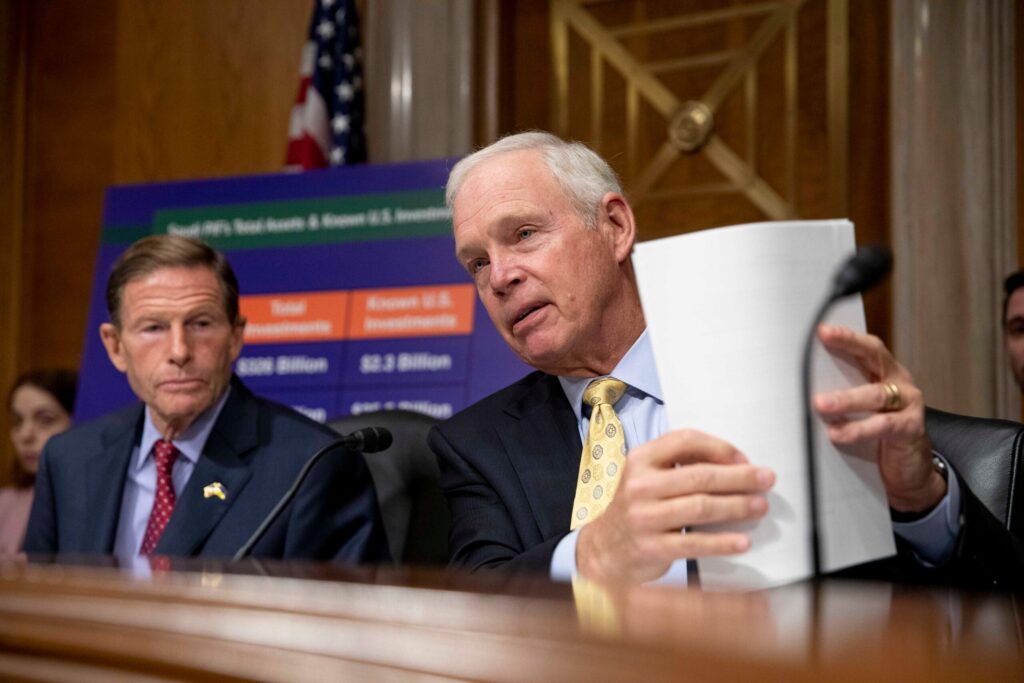 Sen. Ron Johnson holds papers during a congressional subcommittee meeting on Capitol Hill