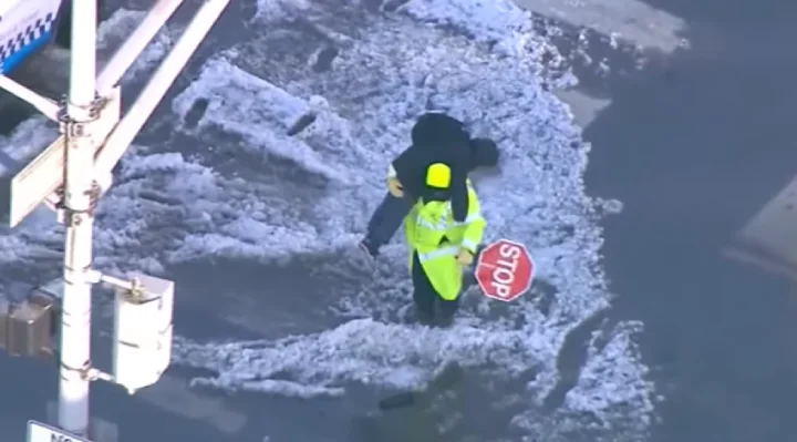 Crossing Guard Carries Kids Across A Water-Soaked Chicago Street
