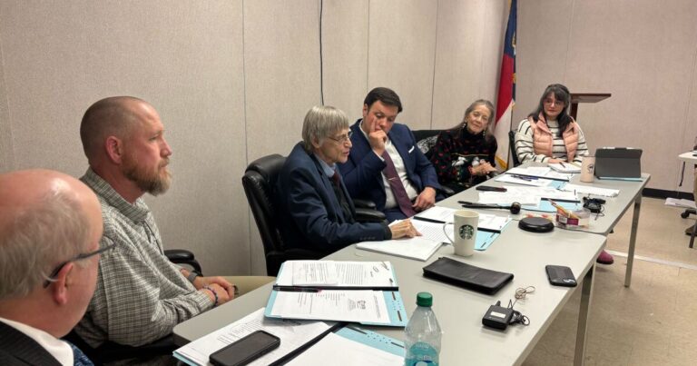 Community members filled available seating, with many more listening to the meeting from a speaker outside.