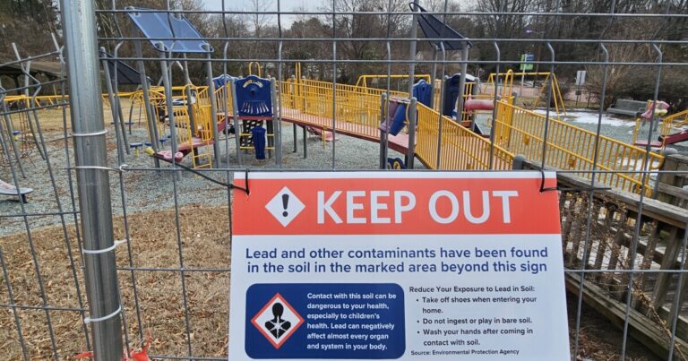 Trash litters East End Park in Durham, which is fenced off due to lead contamination concerns.