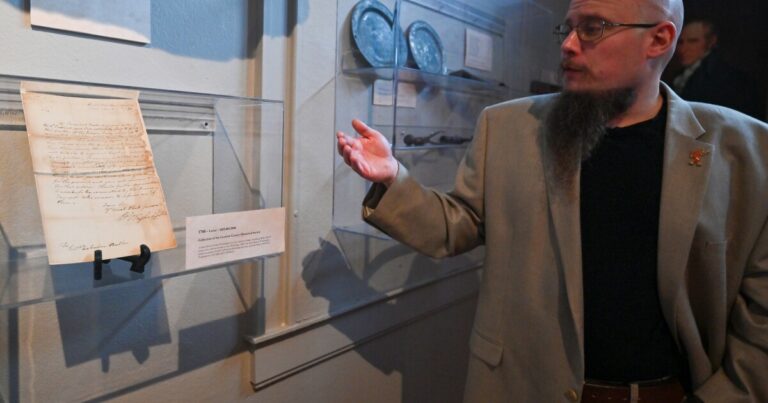 A painting of Julia Sobon Potora who lived in Wilkes-Barre hangs near antique laundry tools in the Luzerne County Historical Society Museum.