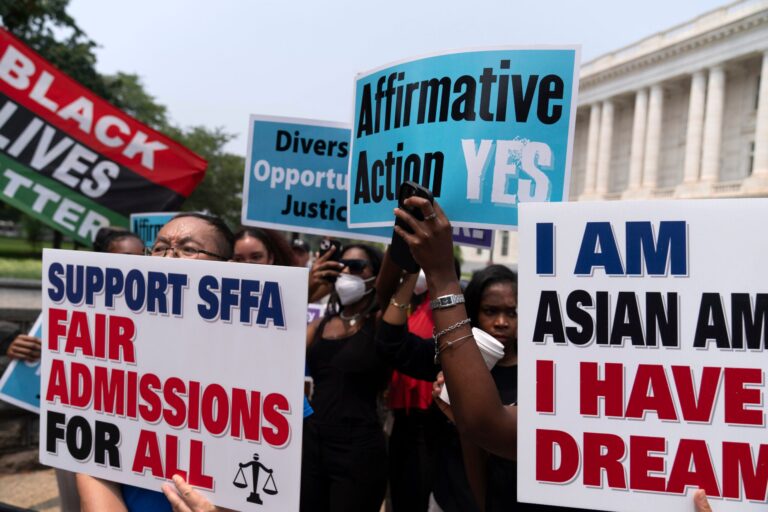 Protesters holding signs outside the U.S. Supreme Court building