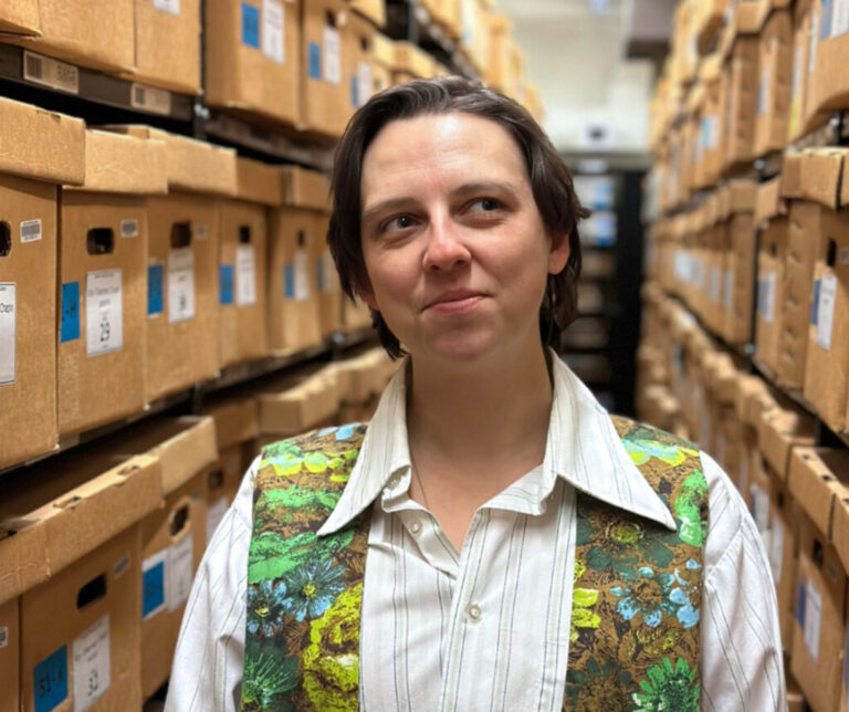 Carolyn Alam, an archivist for university collections at the Bentley Historical Library, photographed among boxes of archived material.