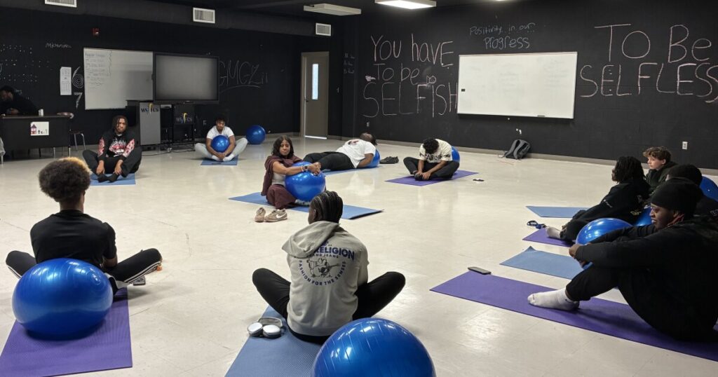 Carver High School students sit on their yoga mats in the "Restoration Room."