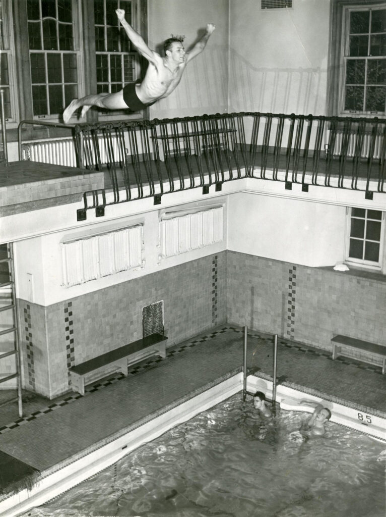 A student, circa 1930, leaps from the Union pool’s diving board.
