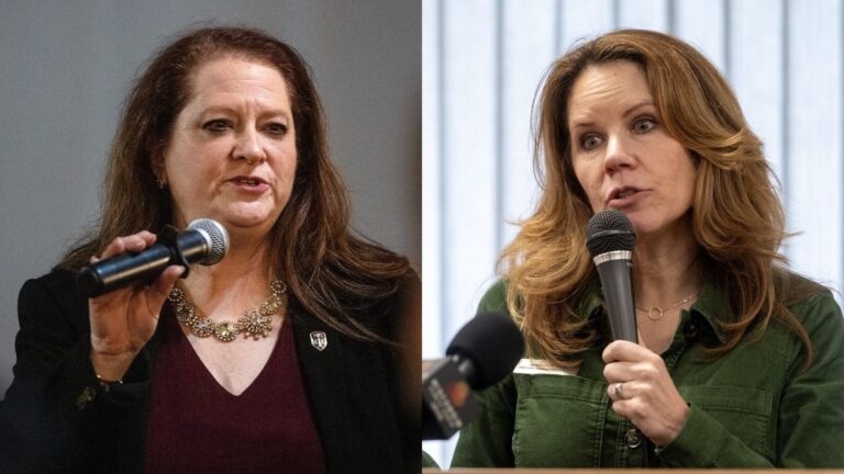 Two women speaking into microphones; the woman on the left wears a dark blazer and maroon top, while the woman on the right wears a green shirt and stands in front of a window.
