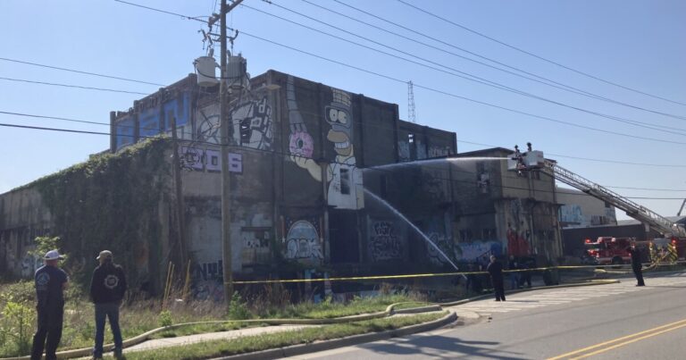 ScareKrow stands in front of the planned Salvage Station site Friday, April 24, 2026.