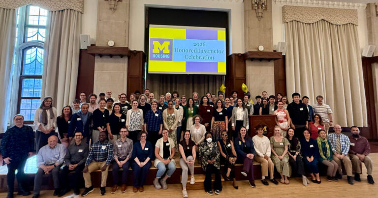 A group of dozens of people posing for a photo under a sign that says "2026 Honored Instructor Celebration"