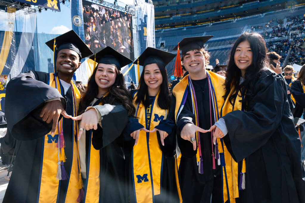 5 students posing prior to a graduation ceremony