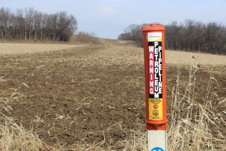 An Enbridge post marks the Line 61 corridor in a field in Marshall, Wisconsin.