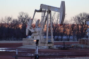 A gas flare burns in front of an oil pumpjack near Killdeer, North Dakota in 2024. North Dakota and South Dakota had large increases in personal income for the first quarter as oil prices rose, but little to no economic growth after inflation. (Photo by Jeff Beach/North Dakota Monitor)