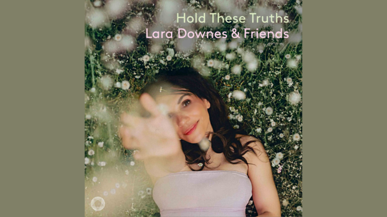 A woman in a light dress lies on grass surrounded by white flowers, reaching toward the camera. Text reads: Hold These Truths Lara Downes & Friends.