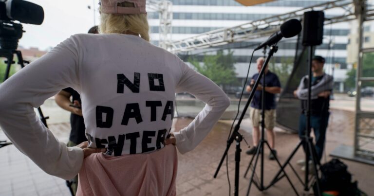 Christine Fazzi, of Bear Creek Twp., listens as Todd Eachus, Butler Twp., talks about data centers at a protest in Wilkes-Barre.