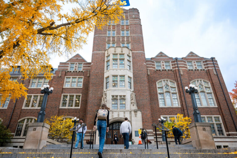 Photo of the Michigan union with a tree with yellow leaves in the foreground