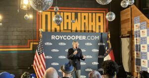 Members of the audience listen during Democratic Senate nominee Roy Cooper's event at Oklawaha Brewing Co. in Hendersonville Thursday, Aug. 20, 2026.