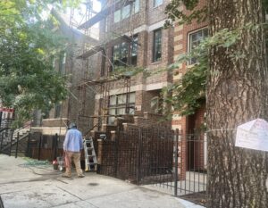 A person works on a condominium in Chicago. Some U.S. cities are trying to modernize the housing permitting process by adopting AI tools. (Photo by Robbie Sequeira/Stateline)