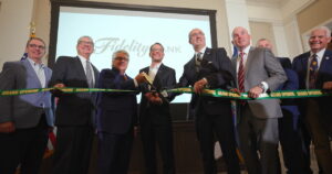Lackawanna County Commissioner Thom Welby, left, state Rep. Kyle Donahue, state Rep. Bridget Kosierowski, state Sen. Marty Flynn, Brian Cali, chair of the Fidelity Bank Board of Directors; Governor Josh Shapiro and Daniel J. Santaniello, Fidelity Bank President and Chief Executive Officer, watch a video about the renovations to the Scranton Electric Building.