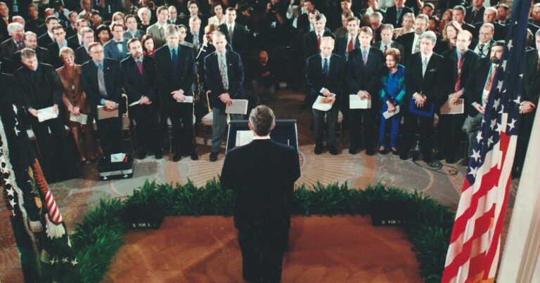 Chief of Staff Andy Card whispers into the ear of President George W. Bush to give him word of the planes that slammed into the World Trade Center in New York, on Sept. 11, 2001.