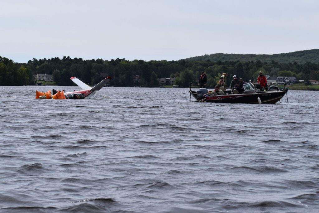 The tail of the airplane, cutting through the waves like a shark's fin, as it's pulled to dry land. Avery Martinez / WPR