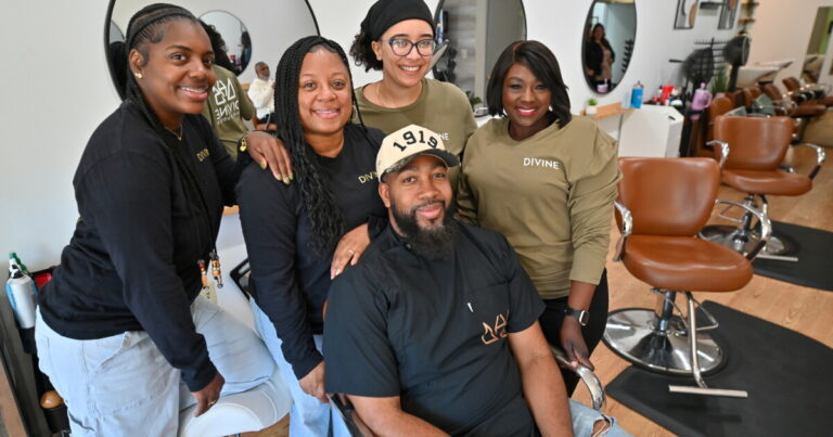 Divine Hair Studios co-owner Monique Williams (left) Tennille Hill, an OurHAIR trainer and salon owner in Mechanicsburg, laugh while discussing the OurHAIR initiative. Wendy Zaccone and Lori Weems (right) were also at the salon for a visit.