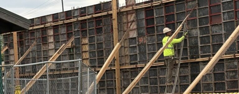 A construction worker wields a hammer on the job at the Mill Creek Residential project in Paramus, N.J., in May 2026. The supply of skilled workers in construction and other trades is under pressure from aging, immigration enforcement and a rush to build data centers. (Photo by Tim Henderson/Stateline)